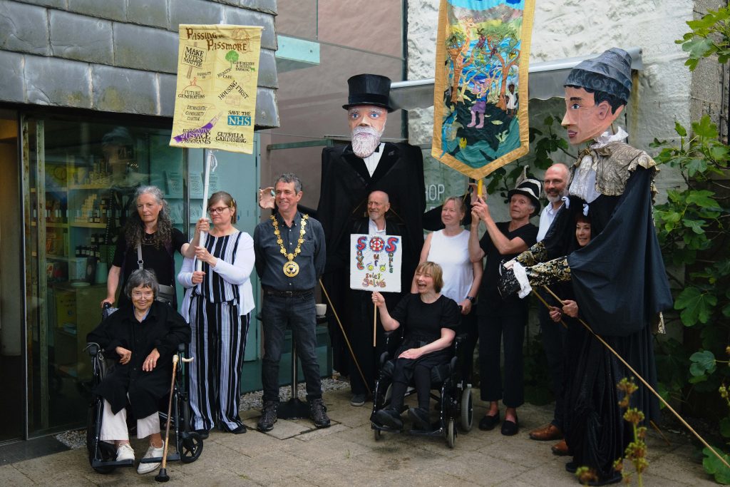 Image shows Shalla Arts group at Newlyn Art Gallery with Passmore edwards pupets and banners