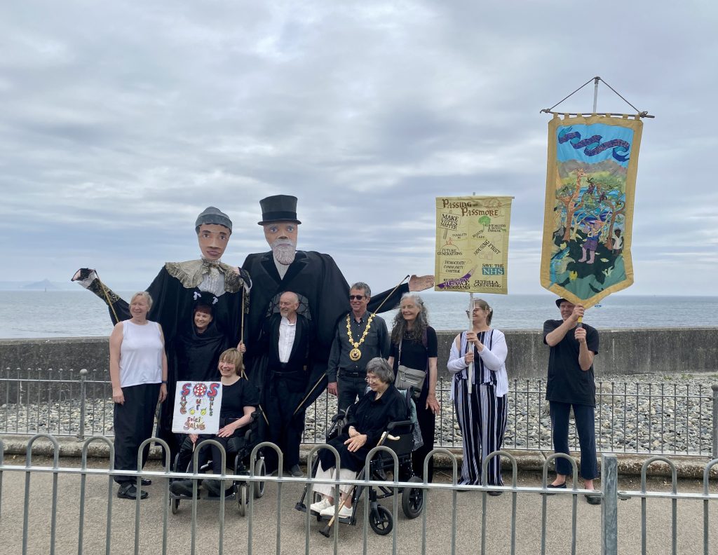 Image shows Shalla Arts group at Newlyn Art Gallery with Passmore edwards pupets and banners